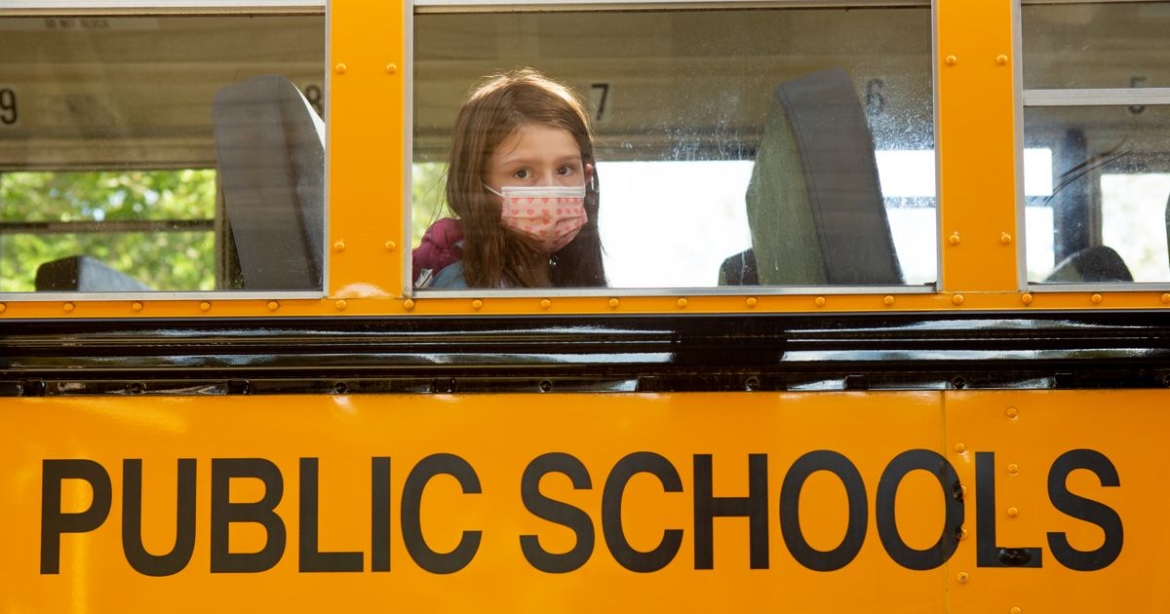 Student with mask on bus
